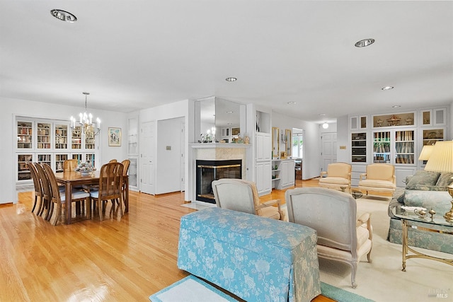 607 Tobin Dr, Vallejo, CA 94589 - living room featuring light wood-type flooring, a chandelier, a fireplace, and recessed lighting