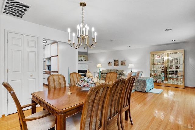 607 Tobin Dr, Vallejo, CA 94589 - dining space with light wood-style flooring, a chandelier, a fireplace, and recessed lighting