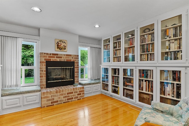 607 Tobin Dr, Vallejo, CA 94589 - sitting room with light wood finished floors, a brick fireplace, plenty of natural light, and recessed lighting