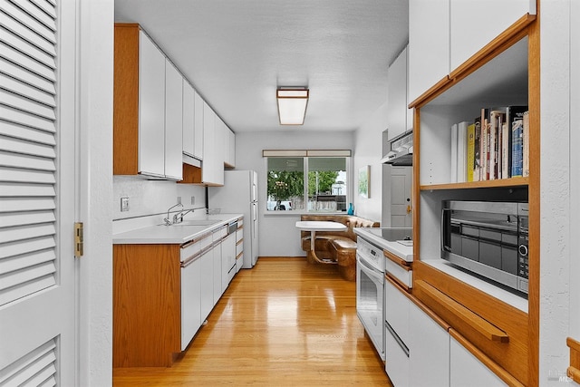 607 Tobin Dr, Vallejo, CA 94589 - kitchen featuring stainless steel microwave, white oven, white cabinets, and a sink