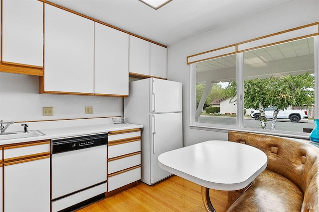 607 Tobin Dr, Vallejo, CA 94589 - kitchen featuring white appliances, a sink, white cabinets, light countertops, and light wood-type flooring