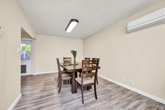 2298 Janette Dr, Napa, CA 94558 - dining area with a wall unit AC, light wood-style floors, and baseboards