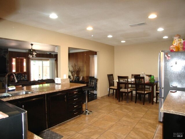 1994 Cardinal Way, Fairfield, CA 94533 - kitchen with a sink, freestanding refrigerator, recessed lighting, dark cabinets, and light stone counters