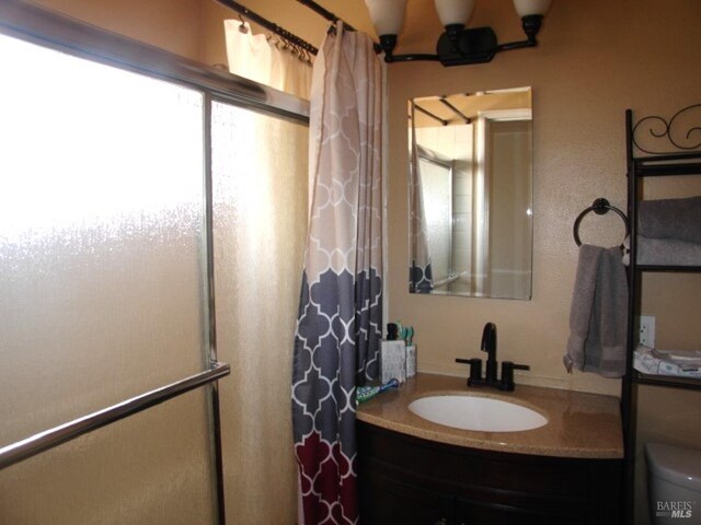 1994 Cardinal Way, Fairfield, CA 94533 - bathroom with a shower with curtain, vanity, and toilet