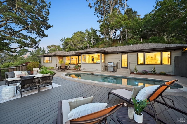 510 Redwood Rd, San Anselmo, CA 94960 - back of property at dusk with a wooden deck, outdoor lounge area, an outdoor pool, and outdoor dining area