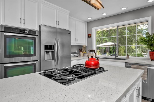 3371 Crystal Ct, Napa, CA 94558 - kitchen featuring appliances with stainless steel finishes, a sink, white cabinets, light stone counters, and recessed lighting