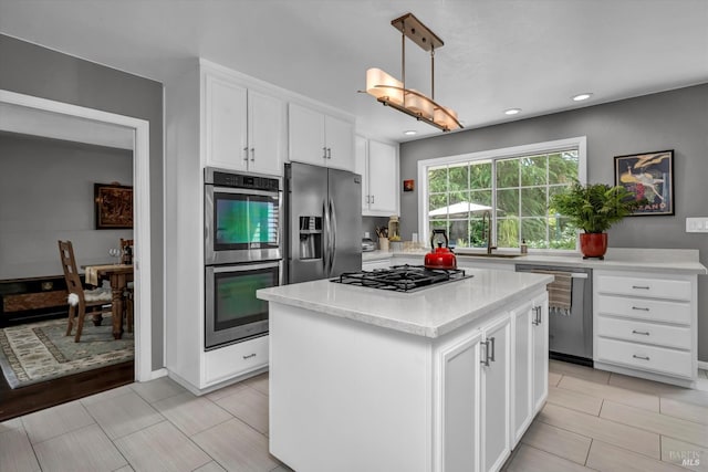 3371 Crystal Ct, Napa, CA 94558 - kitchen with appliances with stainless steel finishes, light countertops, white cabinets, a center island, and a sink