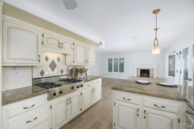 4078 Tokay Dr, Napa, CA 94558 - kitchen featuring stainless steel gas stovetop, light wood-type flooring, backsplash, dark stone counters, and open floor plan