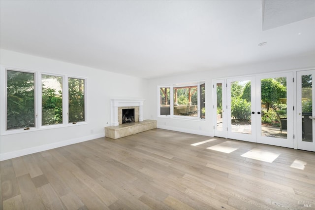 4078 Tokay Dr, Napa, CA 94558 - unfurnished living room with french doors, light wood finished floors, a fireplace, and baseboards