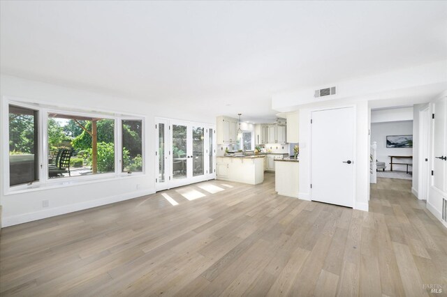 4078 Tokay Dr, Napa, CA 94558 - unfurnished living room featuring light wood-type flooring, baseboards, and french doors