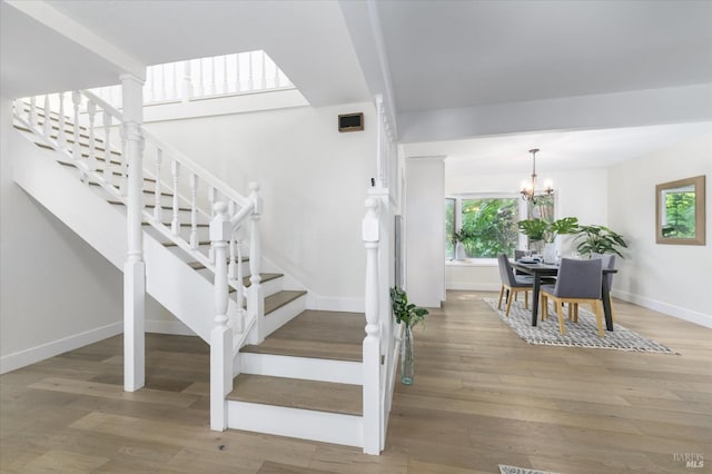 4078 Tokay Dr, Napa, CA 94558 - stairway with baseboards, wood finished floors, and a chandelier