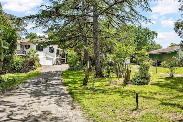 1466 Cooper Rd, Sebastopol, CA 95472 - view of front of house with asphalt driveway, a front yard, stairway, and a garage
