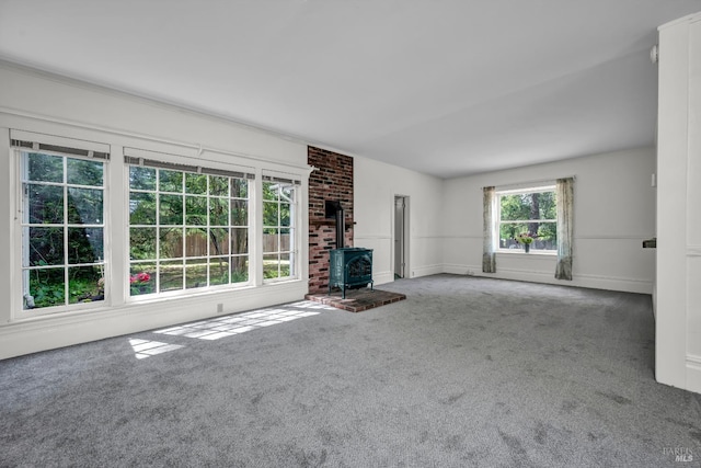 1466 Cooper Rd, Sebastopol, CA 95472 - unfurnished living room featuring a wood stove, carpet flooring, and baseboards