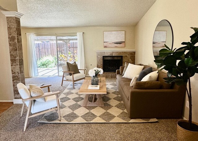 3 Clemson Ct, Woodland, CA 95695 - carpeted living area with a tiled fireplace, a textured ceiling, and decorative columns