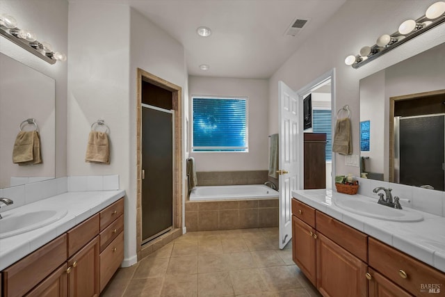 17962 Bunker Rd, Hidden Valley Lake, CA 95467 - full bathroom with a stall shower, tile patterned flooring, two vanities, and a garden tub