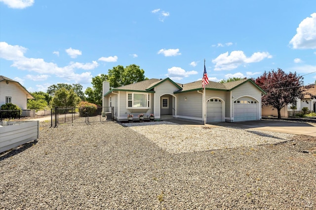 17962 Bunker Rd, Hidden Valley Lake, CA 95467 - ranch-style home featuring concrete driveway, an attached garage, fence, a chimney, and a gate