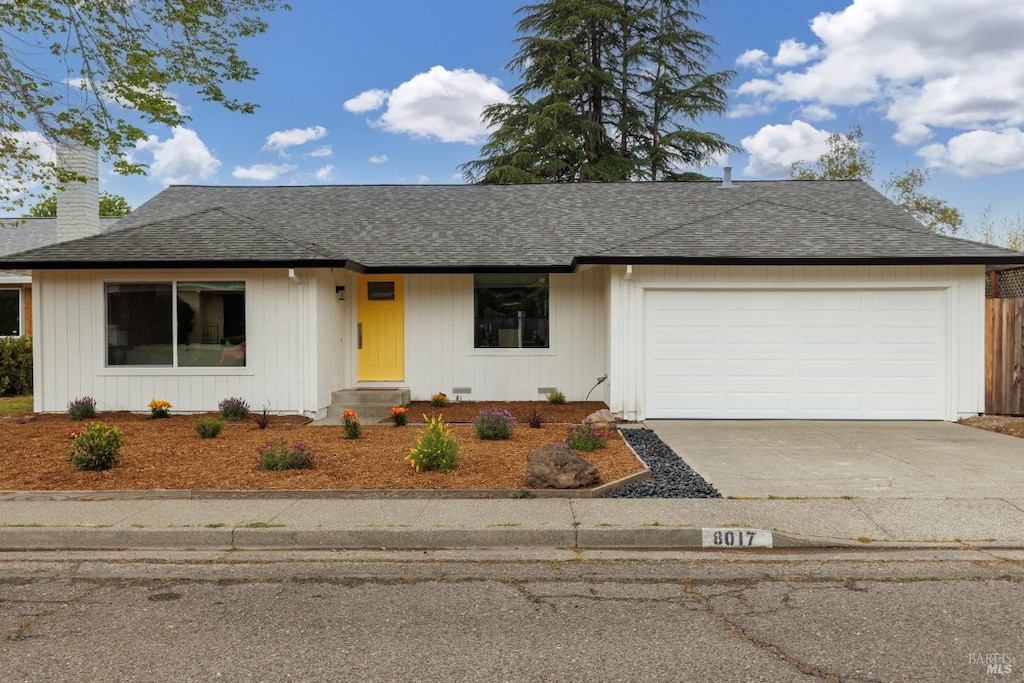 8017 Washington Ave, Sebastopol, CA 95472 - view of front of home featuring concrete driveway, an attached garage, a chimney, and roof with shingles