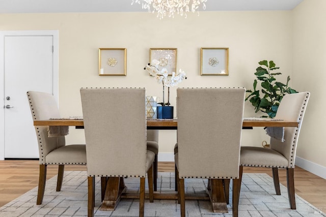8017 Washington Ave, Sebastopol, CA 95472 - dining area with a chandelier, wood finished floors, and baseboards