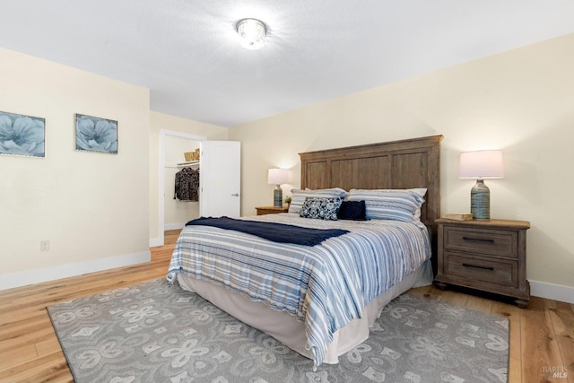 8017 Washington Ave, Sebastopol, CA 95472 - bedroom featuring light wood-style flooring, baseboards, a walk in closet, and a closet