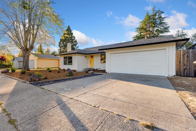 8017 Washington Ave, Sebastopol, CA 95472 - single story home with a chimney, concrete driveway, fence, and a garage