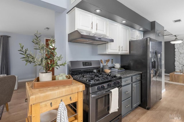 2835 Owens St, Fairfield, CA 94534 - kitchen with under cabinet range hood, stainless steel appliances, white cabinets, light wood finished floors, and recessed lighting