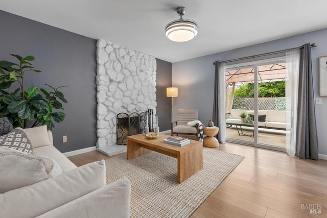 2835 Owens St, Fairfield, CA 94534 - living room featuring wood finished floors, a stone fireplace, and baseboards