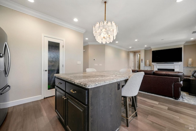 2056 Parsons Dr, Fairfield, CA 94533 - kitchen featuring a breakfast bar area, recessed lighting, wood finished floors, a kitchen island, and baseboards