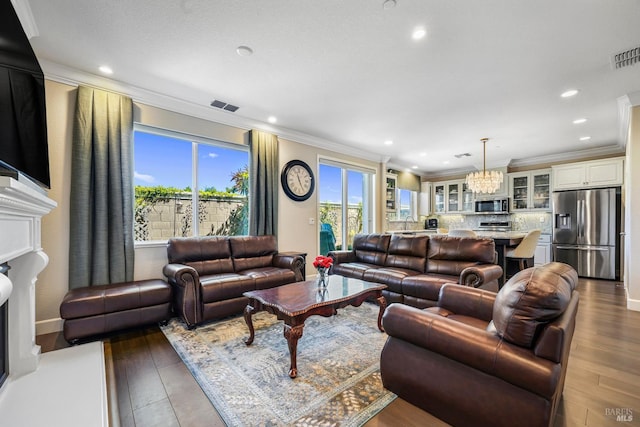 2056 Parsons Dr, Fairfield, CA 94533 - living area featuring wood finished floors, a chandelier, ornamental molding, recessed lighting, and a fireplace