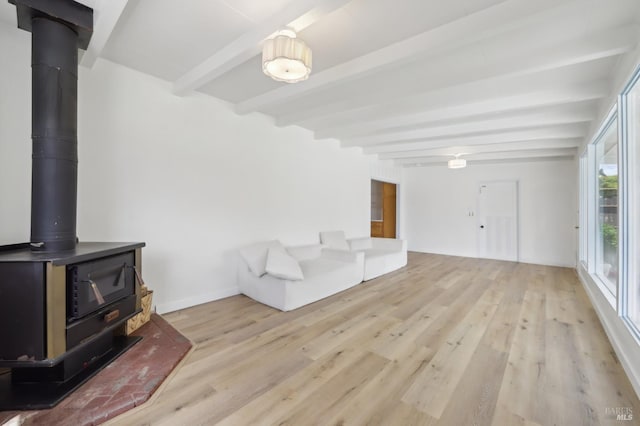 2889 Keller Ct, Napa, CA 94558 - unfurnished living room with a wood stove, beam ceiling, light wood-style floors, and baseboards