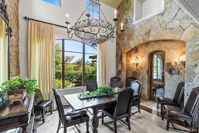 7035 Silverado Trl, Napa, CA 94558 - dining space with a high ceiling, a chandelier, arched walkways, and healthy amount of natural light