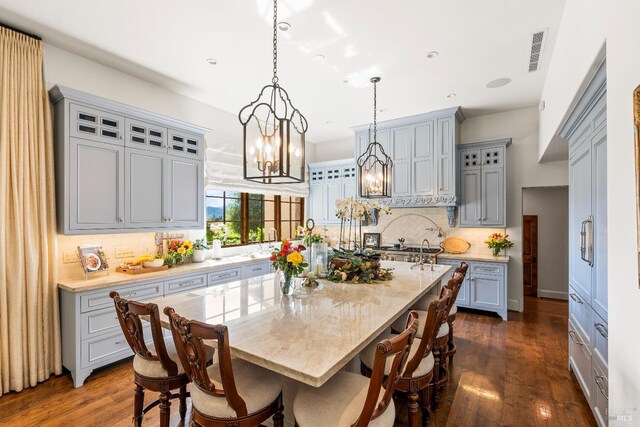 7035 Silverado Trl, Napa, CA 94558 - kitchen with gray cabinetry, tasteful backsplash, a center island with sink, glass insert cabinets, and recessed lighting