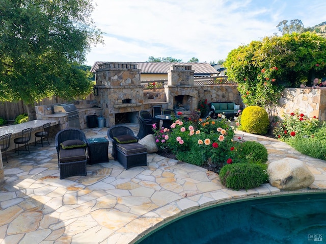 7035 Silverado Trl, Napa, CA 94558 - view of patio featuring an outdoor kitchen, an outdoor living space with a fireplace, grilling area, and fence