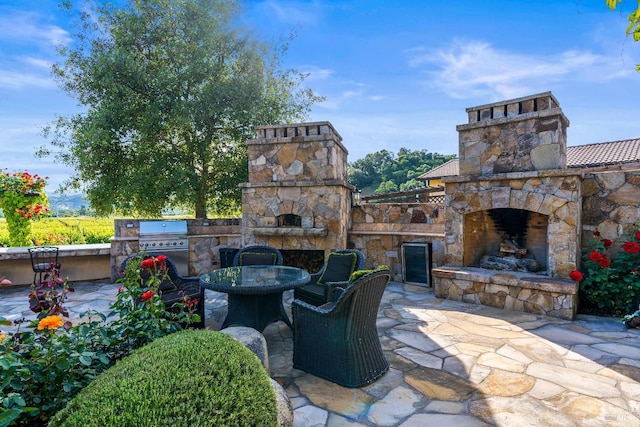 7035 Silverado Trl, Napa, CA 94558 - view of patio / terrace featuring an outdoor stone fireplace, a grill, area for grilling, and outdoor dining area