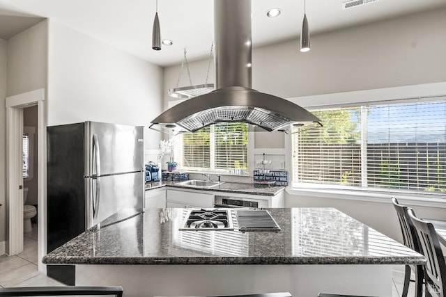 7035 Silverado Trl, Napa, CA 94558 - kitchen featuring island exhaust hood, white cabinets, stainless steel appliances, light tile patterned floors, and a sink