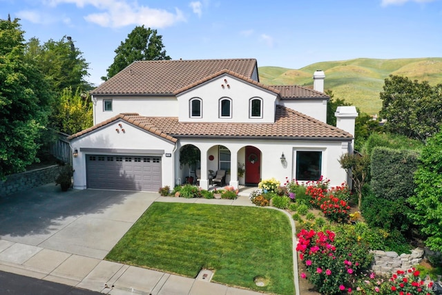 1261 Landmark Dr, Vallejo, CA 94591 - mediterranean / spanish home with a porch, stucco siding, driveway, an attached garage, and a front yard