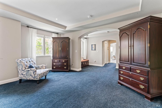 1261 Landmark Dr, Vallejo, CA 94591 - sitting room featuring a raised ceiling, dark carpet, arched walkways, and baseboards