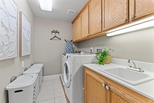 1261 Landmark Dr, Vallejo, CA 94591 - clothes washing area with washer and clothes dryer, cabinet space, light tile patterned floors, and baseboards