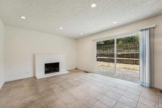 543 Sandy Way, Benicia, CA 94510 - unfurnished living room with recessed lighting, a textured ceiling, tile patterned flooring, a fireplace, and baseboards
