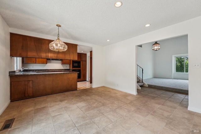 543 Sandy Way, Benicia, CA 94510 - kitchen featuring dark countertops, brown cabinetry, open floor plan, a peninsula, and recessed lighting