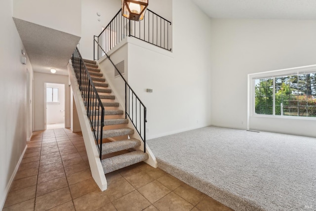 543 Sandy Way, Benicia, CA 94510 - stairway with a towering ceiling, carpet floors, tile patterned floors, and baseboards