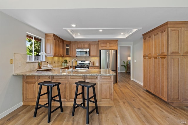 358 Paddlewheel Dr, Vallejo, CA 94591 - kitchen featuring stainless steel appliances, a raised ceiling, a peninsula, decorative backsplash, and baseboards