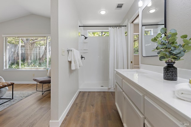 358 Paddlewheel Dr, Vallejo, CA 94591 - bathroom with a shower with shower curtain, wood finished floors, vanity, vaulted ceiling, and baseboards
