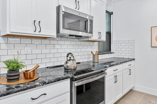 336 Pear Tree Ln Unit D, Napa, CA 94558 - kitchen featuring stainless steel appliances, white cabinetry, dark stone counters, and backsplash