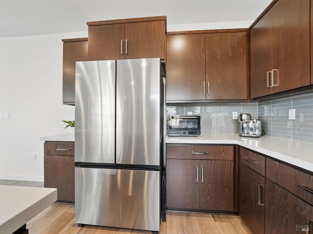 2471 Lake Club Dr, Fairfield, CA 94533 - kitchen featuring freestanding refrigerator, tasteful backsplash, light countertops, light wood-style floors, and baseboards