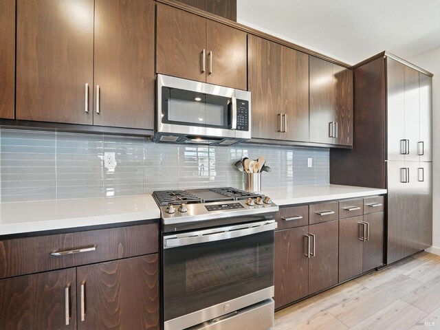 2471 Lake Club Dr, Fairfield, CA 94533 - kitchen featuring stainless steel appliances, light wood-style flooring, light countertops, tasteful backsplash, and dark brown cabinetry