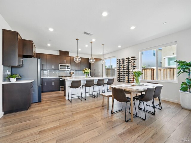 2471 Lake Club Dr, Fairfield, CA 94533 - dining room with light wood finished floors, recessed lighting, and baseboards
