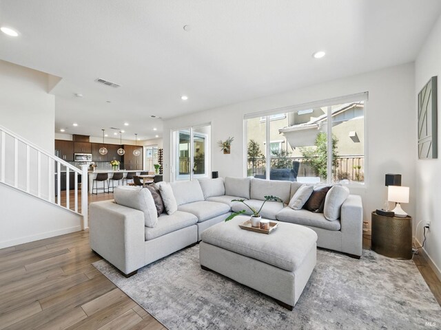 2471 Lake Club Dr, Fairfield, CA 94533 - living area with light wood-style flooring, recessed lighting, stairs, and baseboards