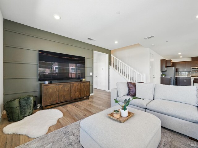 2471 Lake Club Dr, Fairfield, CA 94533 - living area featuring light wood-style flooring, stairway, and recessed lighting
