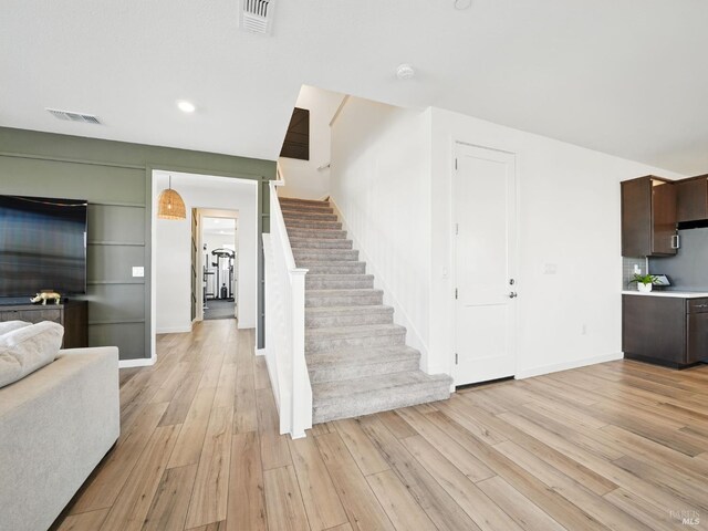 2471 Lake Club Dr, Fairfield, CA 94533 - unfurnished living room with stairway, light wood-style floors, baseboards, and recessed lighting