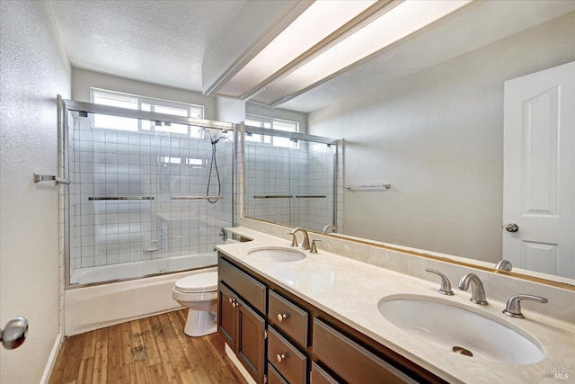 149 Countryview Ct, Vallejo, CA 94591 - full bath with wood finished floors, toilet, double vanity, shower / bath combination with glass door, and baseboards